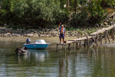 People sitting on boat moored at shore