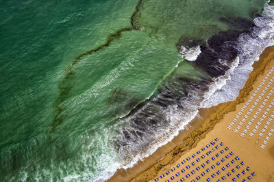 Aerial view of deck chairs arranged on beach