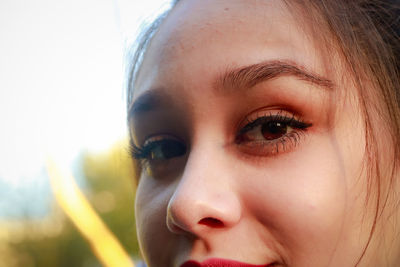 Cropped portrait of young woman with beautiful eyes