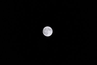 Low angle view of moon against clear sky at night