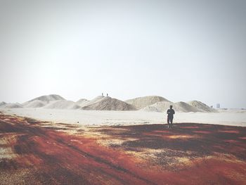 Man standing on mountain against clear sky