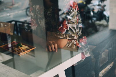 Midsection of woman in a restaurant having food