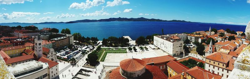 High angle shot of townscape against calm sea