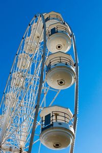 Low angle view of ferries wheel against clear sky