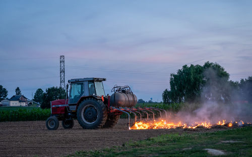 Tractor on field against sky