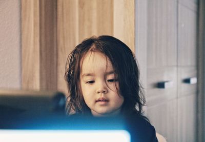 Thoughtful girl sitting at home