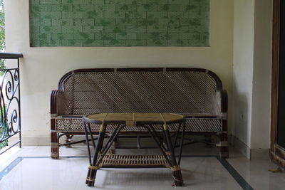 Empty chairs and table in building