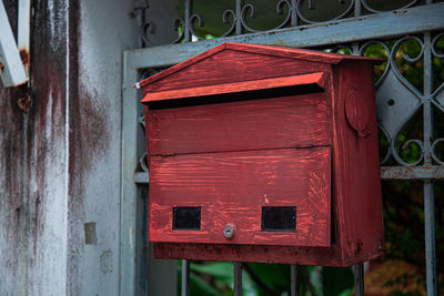 Close-up of red mailbox on door