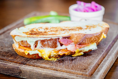 Close-up of sandwich on cutting board at table