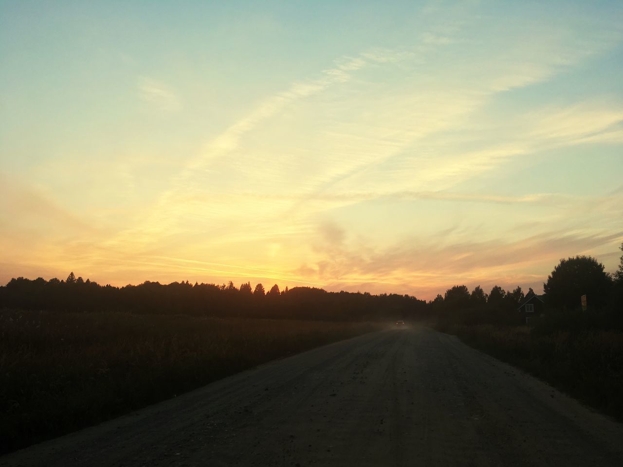 EMPTY ROAD ALONG LANDSCAPE AT SUNSET