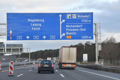 Information sign on highway against sky
