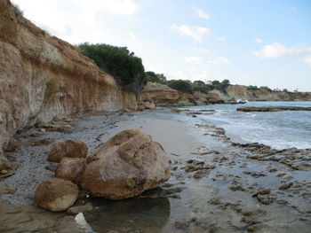 Rocks on beach against sky