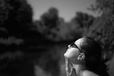 Portrait of young woman looking away outdoors