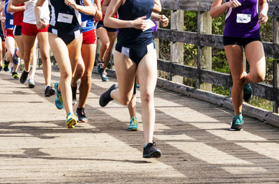 Low section of people running on road