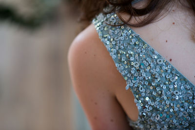 Close-up of young woman wearing sequin dress