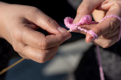 Close-up of hand holding knitting wool