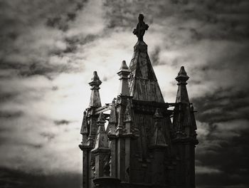 Low angle view of building against cloudy sky