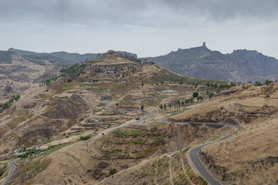 Panoramic view of road leading towards mountains against sky
