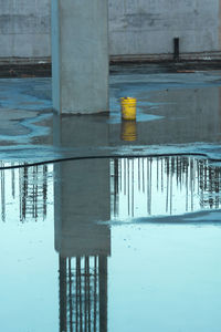 Reflection of built structure in puddle