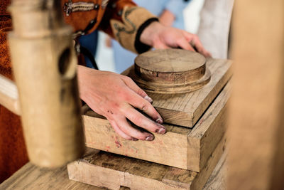 Midsection of man working with wood on table