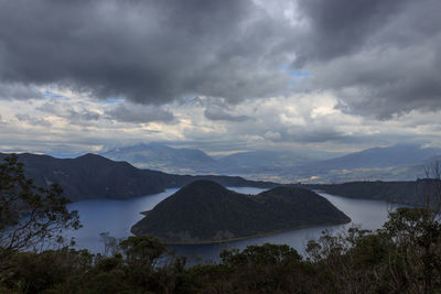 Scenic view of sea and mountains against sky