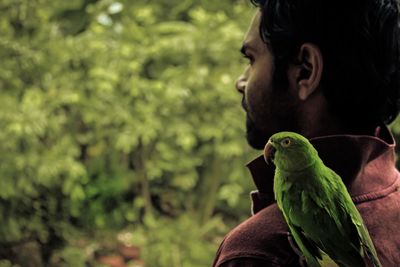 Close-up man with parrot 