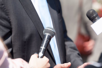 Close-up of hand holding microphone