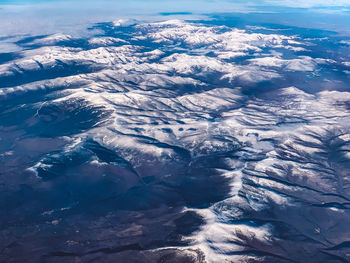 Aerial view of snowcapped mountain against sky