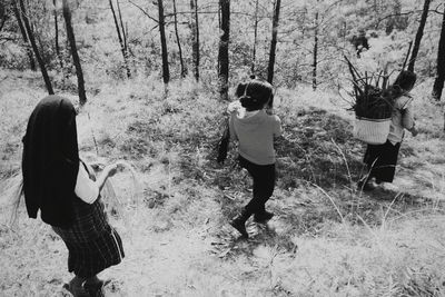 Rear view of women standing on field