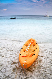 Kayak on the beach with blue sky and the sea background /holiday activities