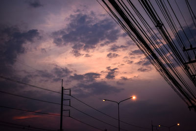 Low angle view of street light against sky during sunset