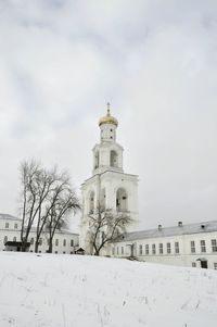 Low angle view of church against sky during winter