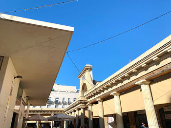 Low angle view of buildings against clear blue sky