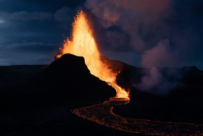 Panoramic view of illuminated mountain against sky at night