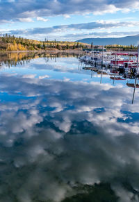 Scenic view of swimming pool by lake against sky
