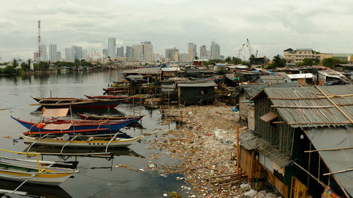 Manila cityscape with slums and dirty river on the background of skyscrapers and business centers 