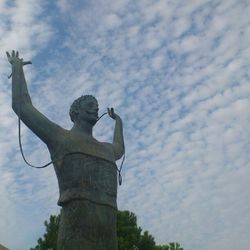 Low angle view of statue against cloudy sky