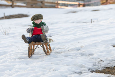 Puppet on snow covered land