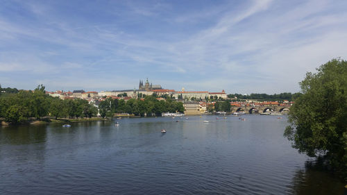 Scenic view of river against sky in city