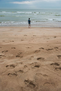 Man standing and looking on sea horizon 