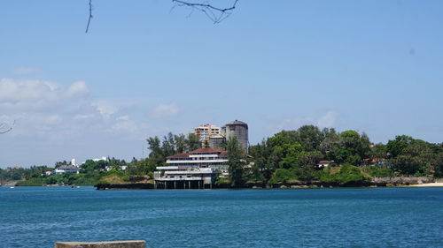 Building by sea against sky