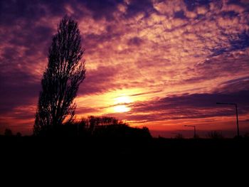 Silhouette of landscape against cloudy sky
