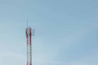 Low angle view of communications tower against sky