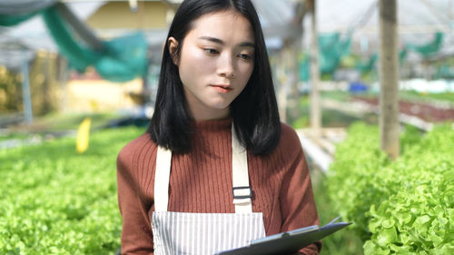 Portrait of beautiful young woman using smart phone outdoors