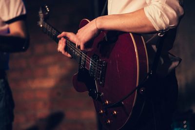 Close-up of man playing guitar