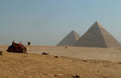 Giza pyramids on desert against clear sky