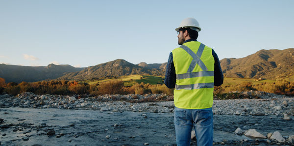 Boy with high visibility harness pilots drone safely