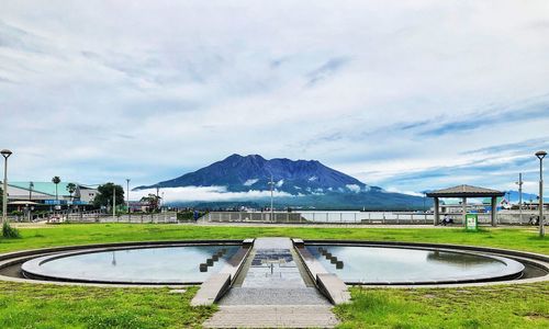 Scenic view of lake by mountains against sky