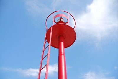 Low angle view of red tower against blue sky