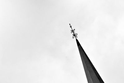 Low angle view of cross on building against sky